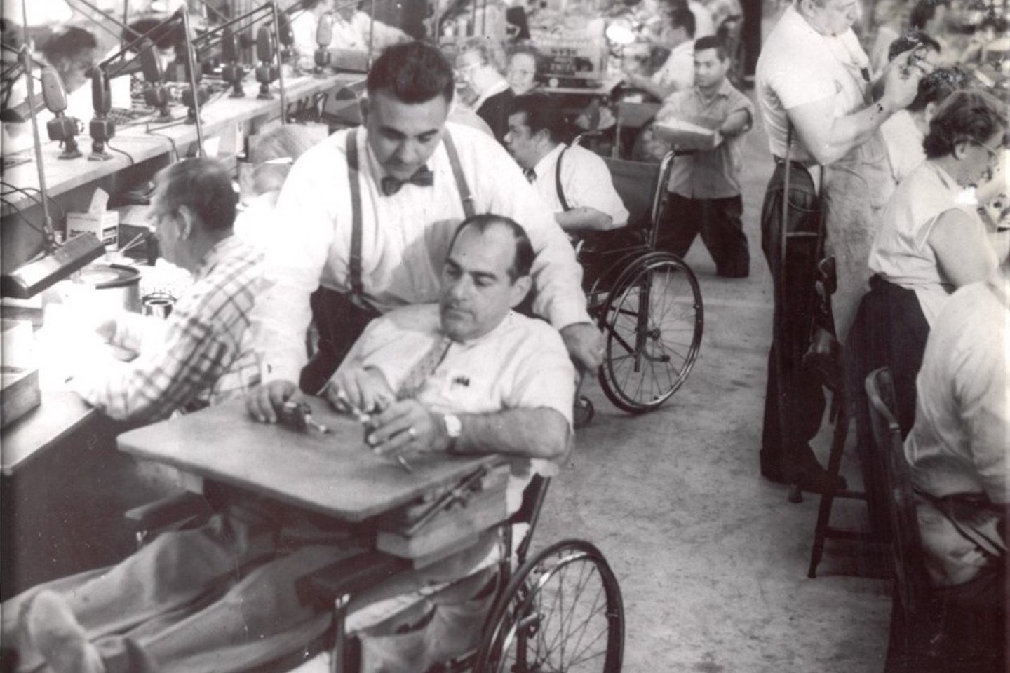 old photo of a man sitting on a wheelchair